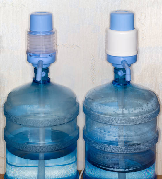 istock Two carboys with drinking water equipped with different hand pumps 2173342344