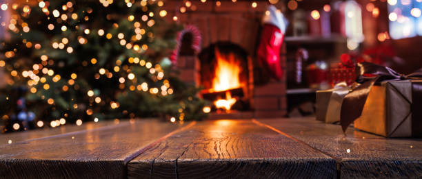 Christmas Tree with Decorations Near a Fireplace with Lights