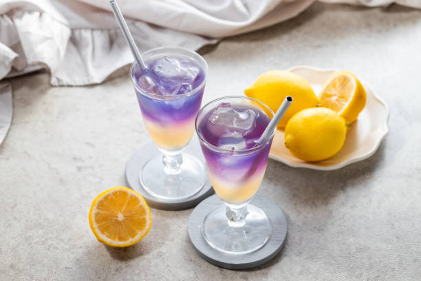 istock Lemonade with blue and violet butterfly pea flower tea on light gray background with copy space 2173344719