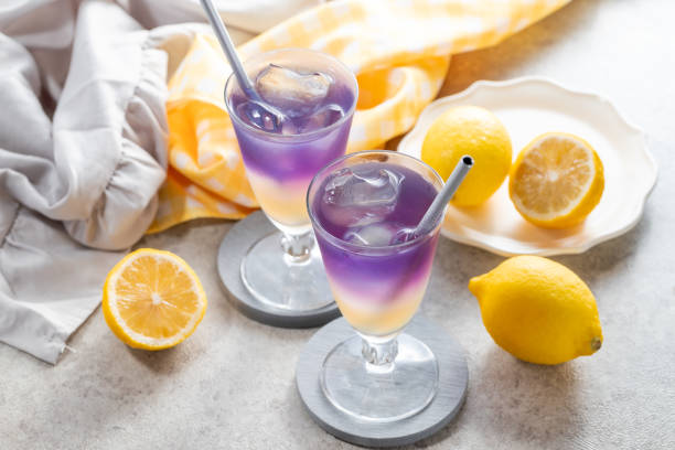 istock Lemonade with blue and violet butterfly pea flower tea on light gray background with copy space 2173344722