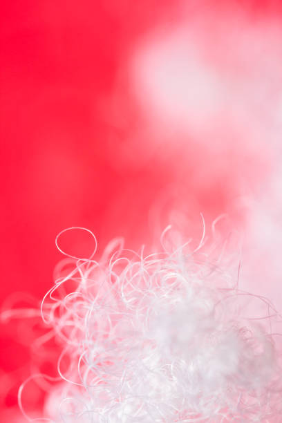 Extreme macro of polyester stable fiber on red background. Selective focus, shallow depth of field. Abstract dreamy background