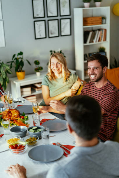 istock Several millennial friends dining at home and laughing. 2173345339