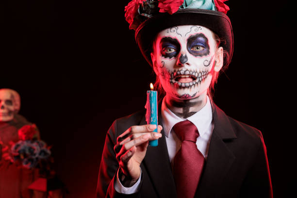 istock Woman playing videogames with controller at Day of the Dead event 2173346607
