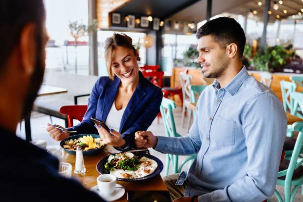 istock Employees having a breakfast meeting outside 2173347293