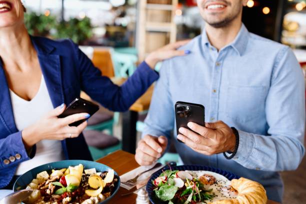 istock Happy coworkers having fun while eating breakfast in a cafe 2173347309