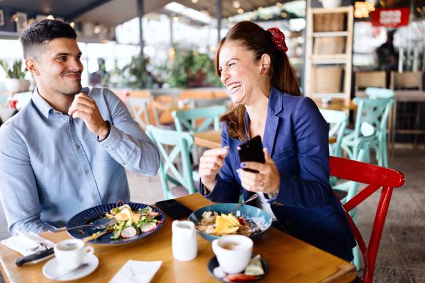 istock Happy coworkers having fun while eating breakfast in a cafe 2173347391