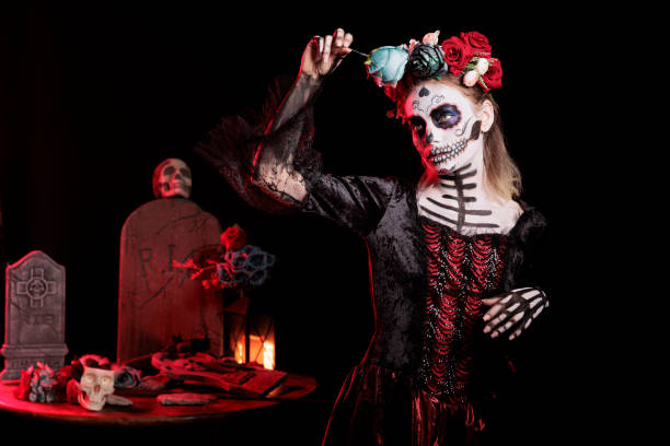 istock Lady holding rose surrounded by gothic funeral items during Halloween event 2173347973