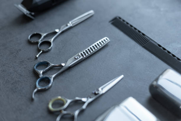 istock Barbershop tools set: scissors, comb, shaving machine and trimmer lie on a gray background. Hairdressing tools set, concept 2173348660