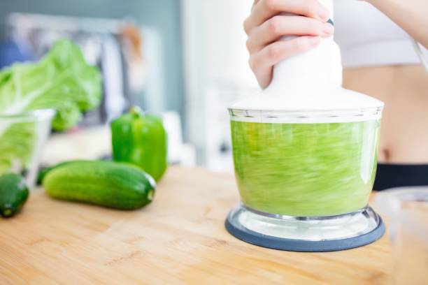istock Asian woman making green smoothie with blender 2173348962