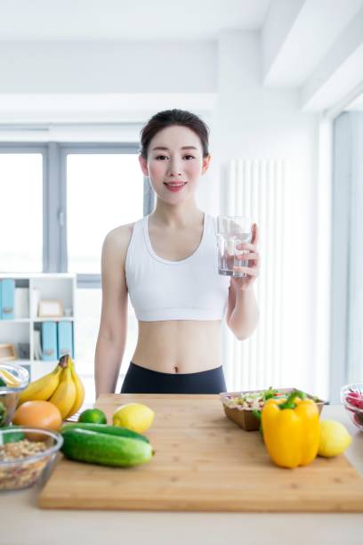 istock Asian woman drinking water in the kitchen 2173349459