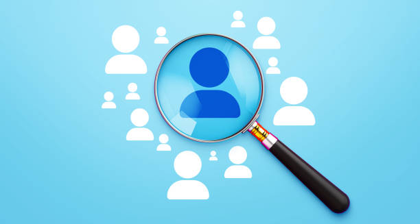 istock Human Resources and Business Leadership Concept – Magnifying Glass Highlighting Dark-Colored Person Icon on a Blue Background. 3D Render. 2173350672