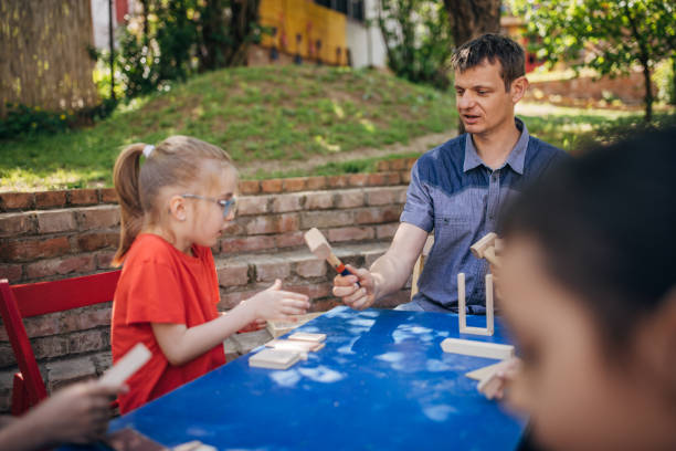 istock Group enjoys outdoor creative activity led by adult. 2173351526