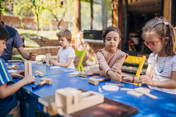 istock Group of children crafting at outdoor activity table 2173351919