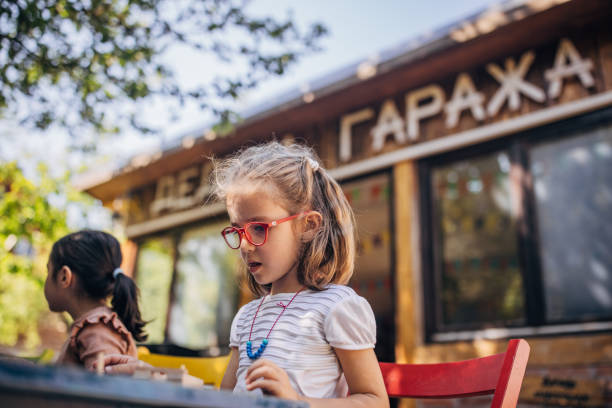 istock Little girl explores creativity at outdoor crafting class. 2173359360