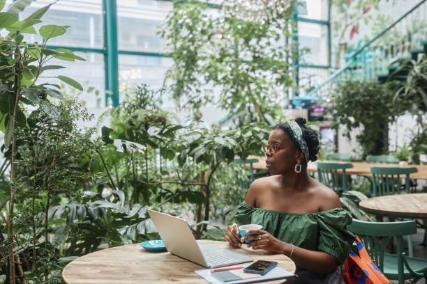 istock Woman Resting in Green Cafe 2173359685