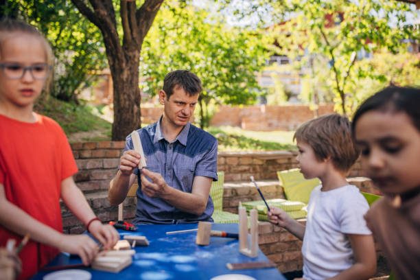 istock Outdoor wood crafting session with instructor guidance. 2173362493