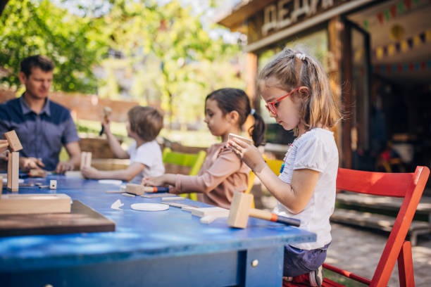 istock Outdoor woodworking workshop for kids with table and tools 2173362785
