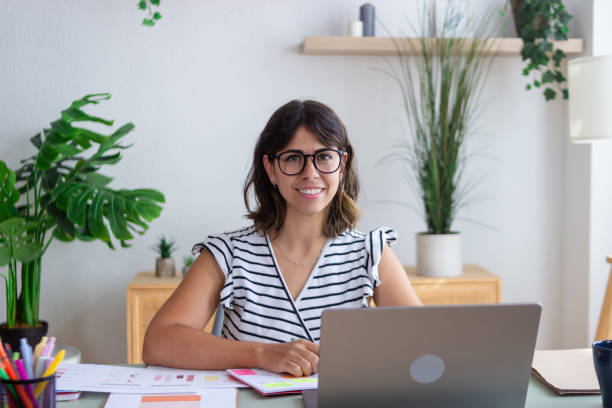 istock Young designer smiling and working from home office 2173363078