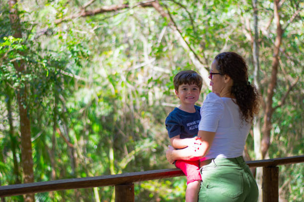 istock Affection of mother with her son in the tropical forest. 2173368794