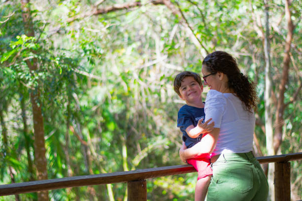 istock Affection of mother with her son in the tropical forest. 2173368809