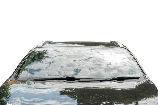 Modern car parked with a blue sky and clouds reflecting in the windshield isolated white background