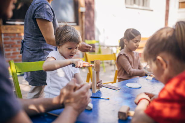 istock Child building blocks while assisted by an adult. 2173371146
