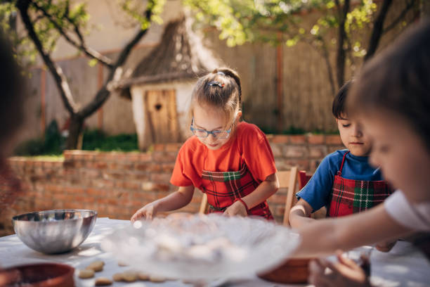 istock Child concentrating on cookie decoration at table 2173371315