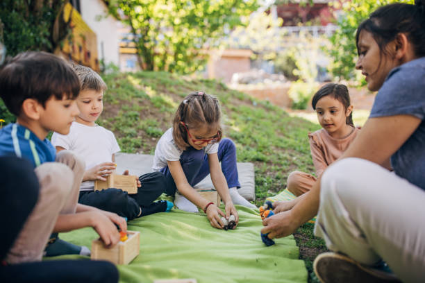 istock Five children playing outdoors with wooden toys. 2173375897