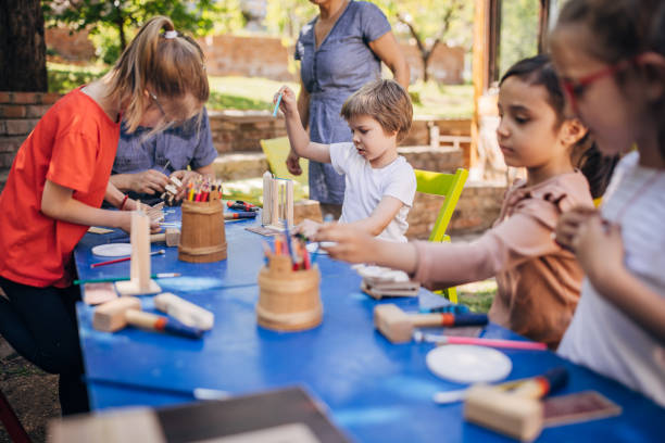 Focused children engaged in vibrant outdoor workshop.