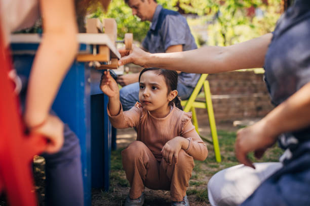 istock Focused toddler involved in a wooden block project. 2173376684