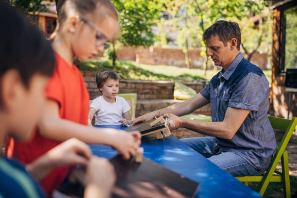 istock Focused woodworking activity with children and teacher. 2173376749