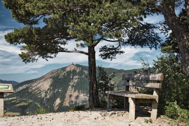 Chorges, France - July 2, 2024. View of a bench placed on a mountain hiking trail, in the heart of the French Alps.