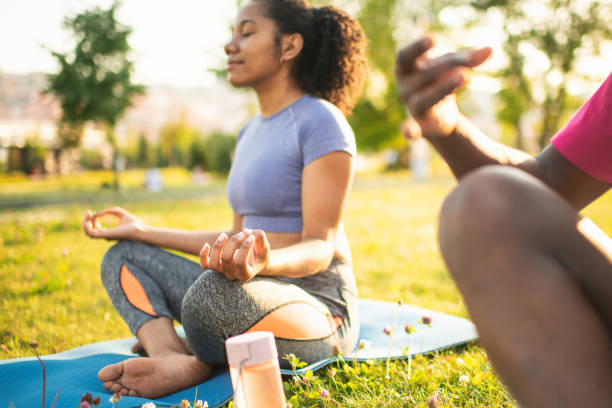 istock Young couple practicing yoga in a summer park 2173382793