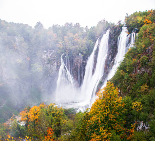 Water tumbling over greenery into pond in Plitvice Lakes Nationa Park in Croatia.