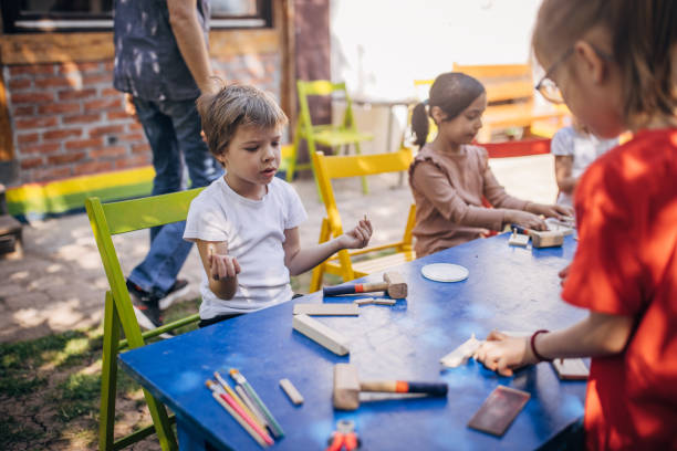 istock Children and instructor enjoy outdoor crafting session 2173384443