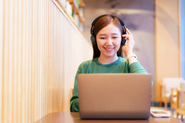 istock Good looking Asian businesswoman is using laptop computer to work and remote conference at cafe. 2173384669