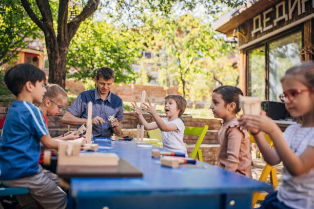 istock Children attentively learning woodworking at a workshop. 2173385124