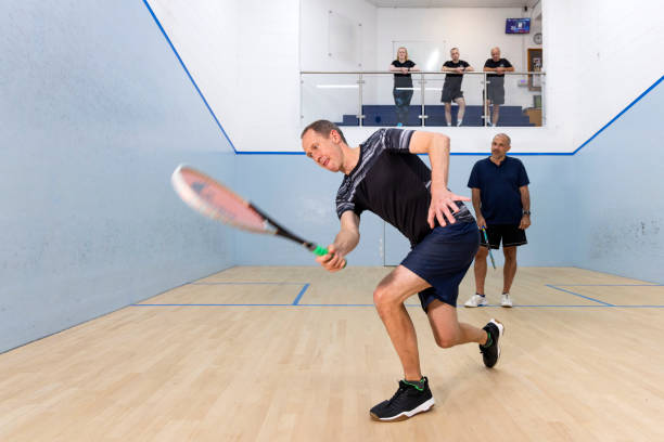 istock Two Male Squash Players Competing with Spectators Watching 2173389983