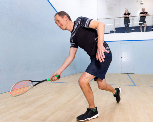 istock Two Male Squash Players Competing with Spectators Watching 2173389985
