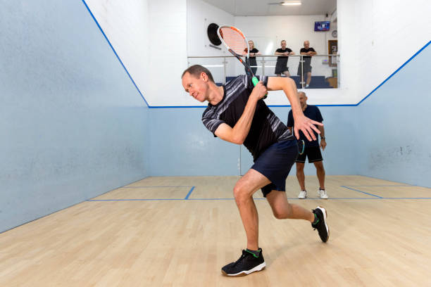istock Two Male Squash Players Competing with Spectators Watching 2173389996