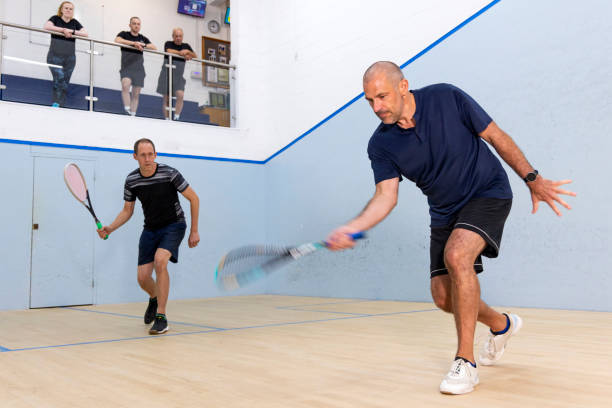 istock Two Male Squash Players Competing with Spectators Watching 2173390014