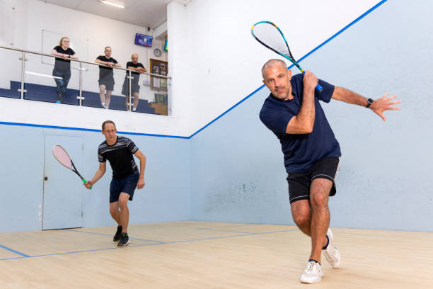 istock Two Male Squash Players Competing with Spectators Watching 2173390020