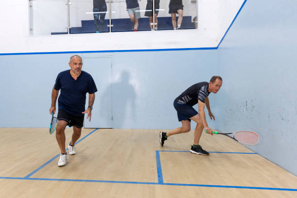 istock Two Male Squash Players Competing with Spectators Watching 2173390039