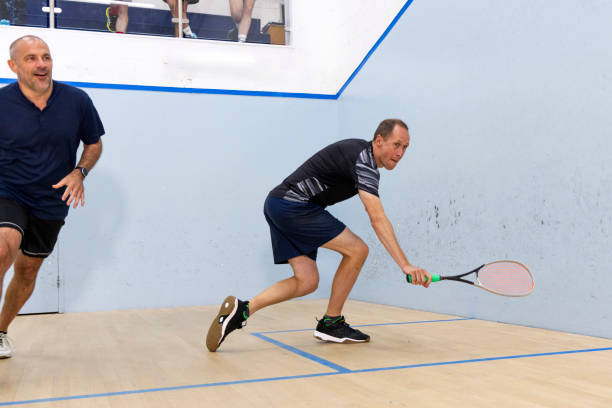 istock Two Male Squash Players Competing with Spectators Watching 2173390044