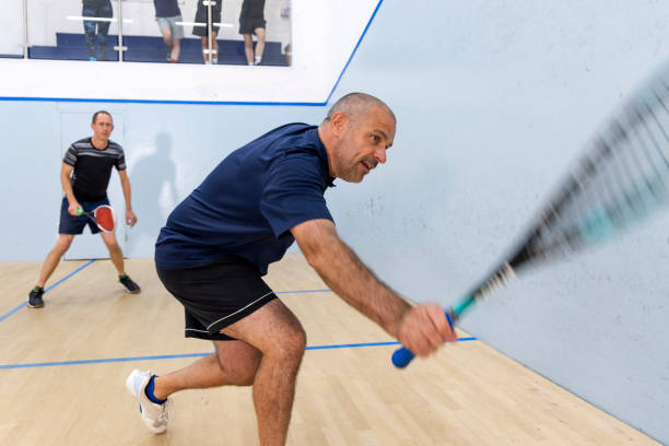 istock Two Male Squash Players Competing with Spectators Watching 2173390058