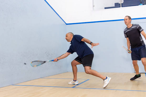 istock Two Male Squash Players Competing with Spectators Watching 2173390065