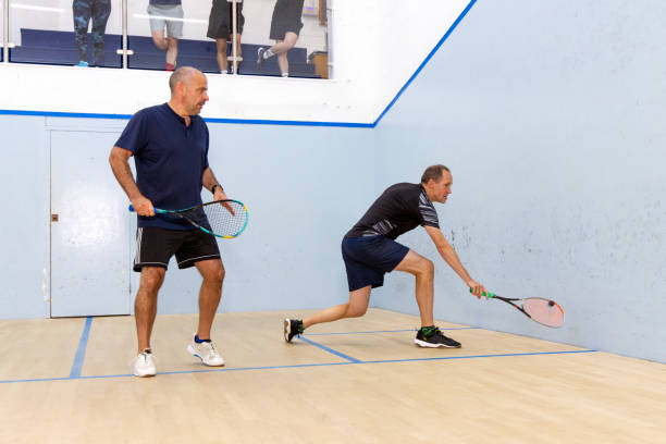 istock Two Male Squash Players Competing with Spectators Watching 2173390101