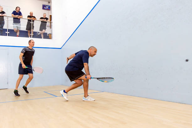 istock Two Male Squash Players Competing with Spectators Watching 2173390116