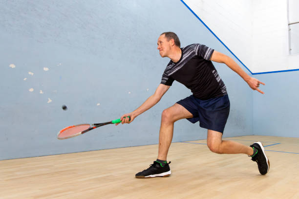 istock Two Male Squash Players Competing with Spectators Watching 2173390142