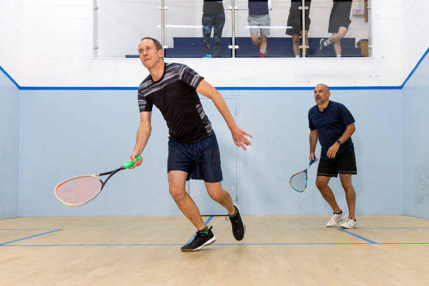 istock Two Male Squash Players Competing with Spectators Watching 2173390159